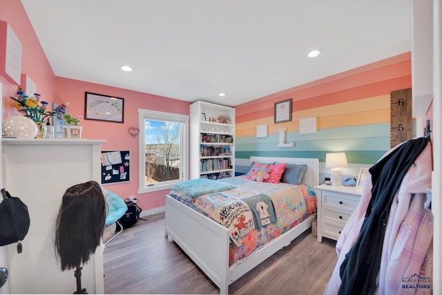 bedroom with baseboards, wood finished floors, and recessed lighting