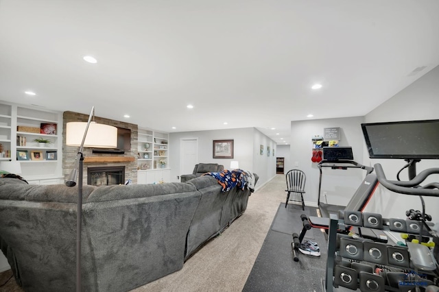 living room featuring baseboards, recessed lighting, a fireplace, and built in features