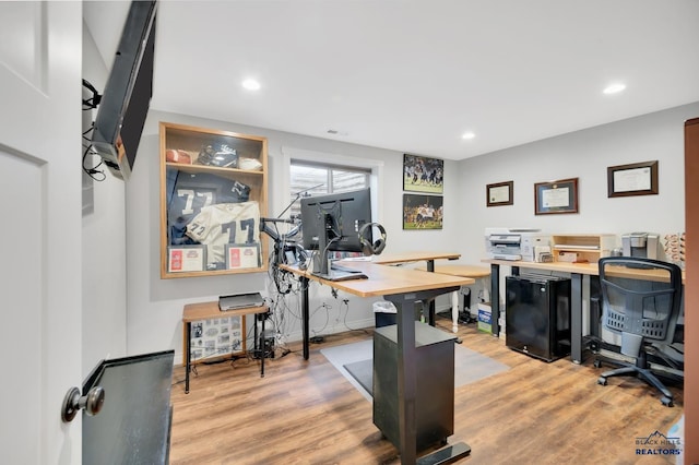 office area featuring light wood finished floors, visible vents, and recessed lighting