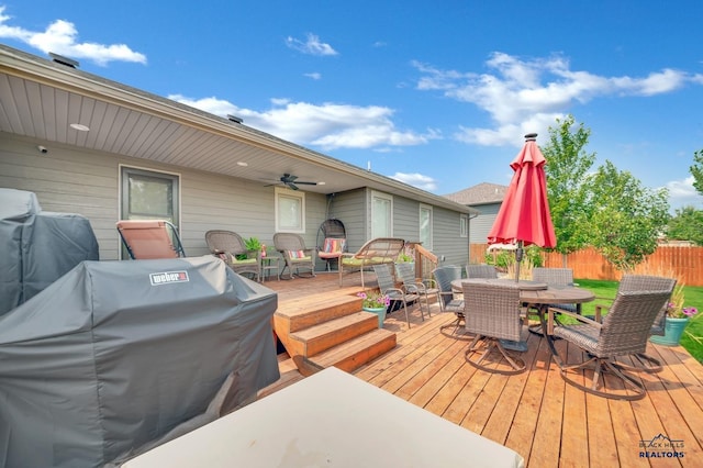 deck featuring ceiling fan, outdoor dining area, fence, and a grill