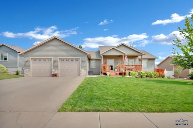 ranch-style home with an attached garage, covered porch, concrete driveway, stone siding, and a front lawn