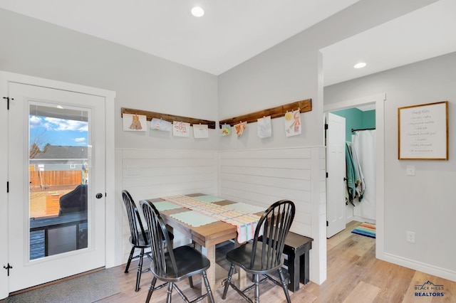 dining room featuring light wood finished floors, baseboards, and recessed lighting