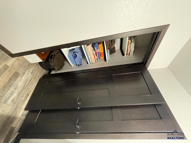 interior details featuring baseboards and wood finished floors