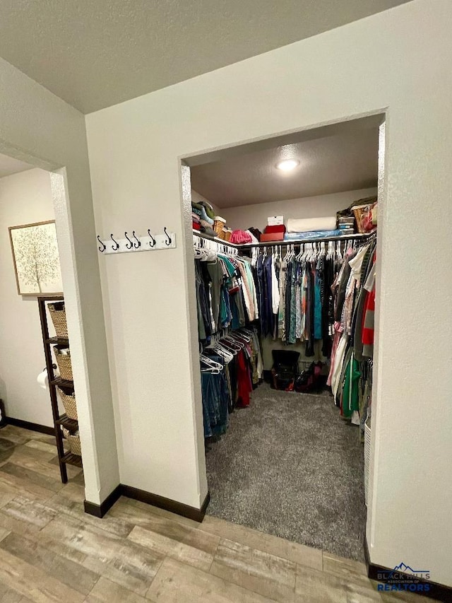 spacious closet featuring wood finished floors