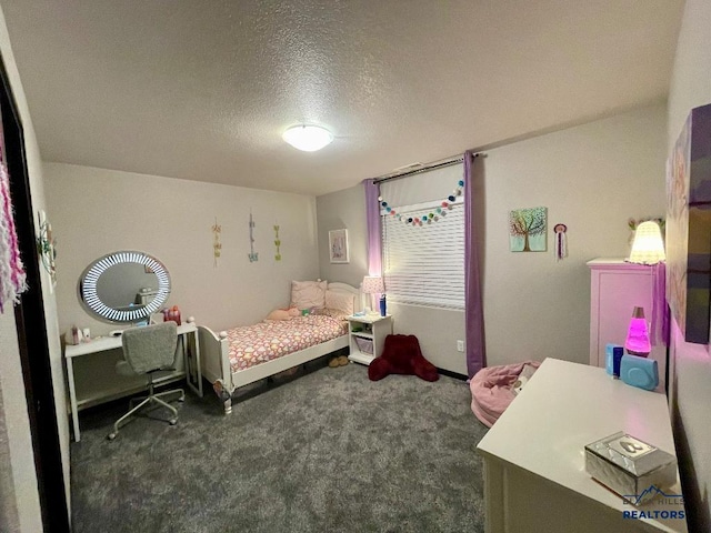 carpeted bedroom with a textured ceiling