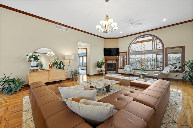 living area featuring plenty of natural light, visible vents, wood finished floors, and a tile fireplace