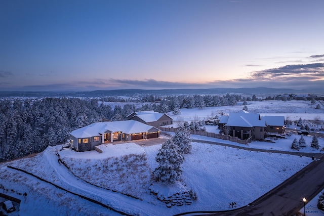 snowy aerial view with a mountain view