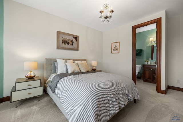 bedroom featuring light carpet, baseboards, ensuite bathroom, and a notable chandelier