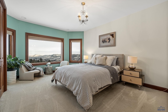 bedroom with carpet flooring, a notable chandelier, and baseboards