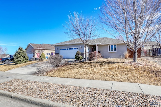 ranch-style home with concrete driveway and an attached garage