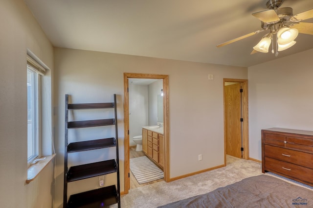 bedroom featuring connected bathroom, baseboards, a ceiling fan, and light colored carpet