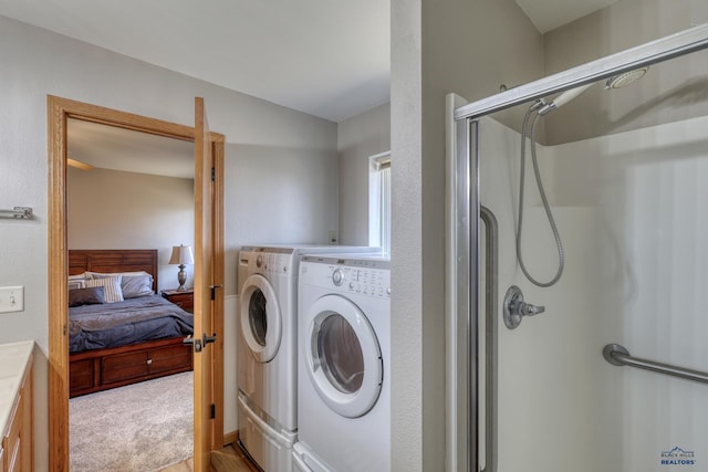 laundry area with laundry area, light carpet, and washer and clothes dryer