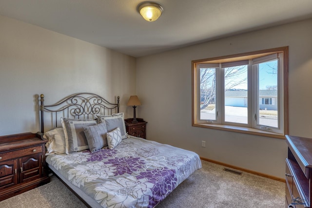 carpeted bedroom featuring visible vents and baseboards