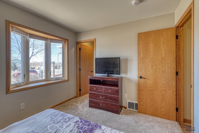 bedroom with carpet, visible vents, and baseboards