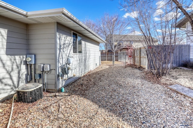 view of property exterior with fence and central air condition unit