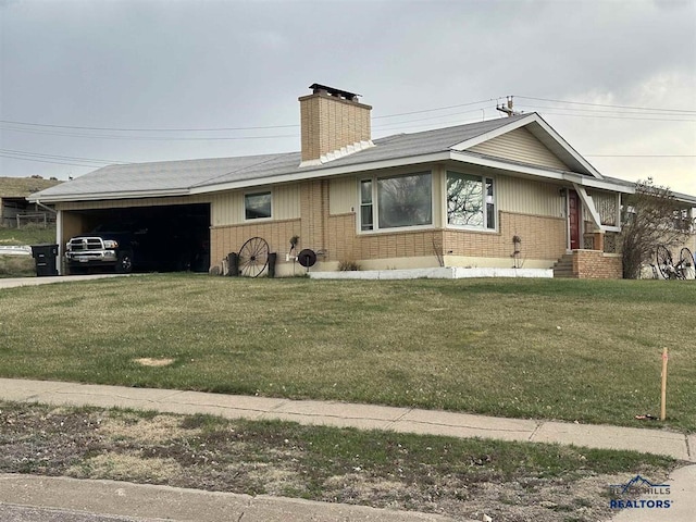 ranch-style home featuring brick siding, an attached garage, and a front yard