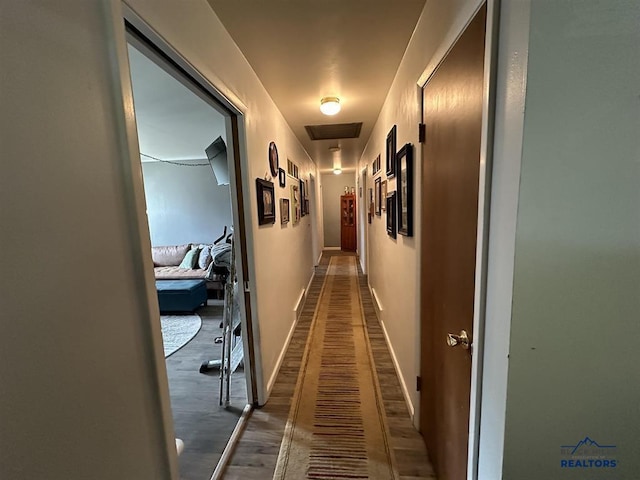 1001 E St, Edgemont, SD 57735 - hall featuring attic access, visible vents, baseboards, and wood finished floors