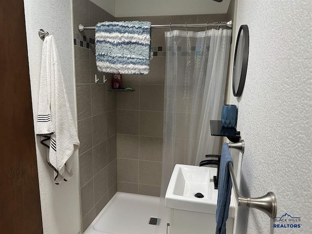 1001 E St, Edgemont, SD 57735 - full bath with a shower stall, a sink, and a textured wall