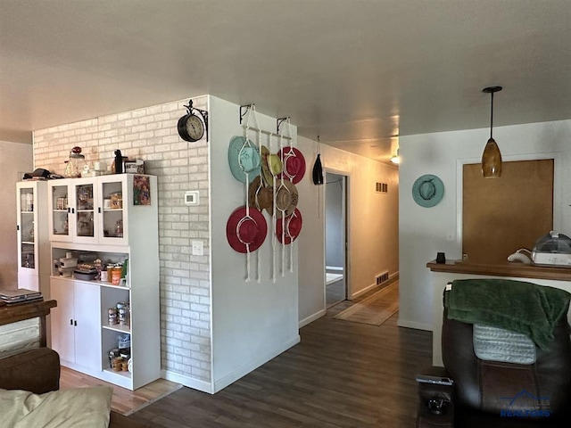 1001 E St, Edgemont, SD 57735 - kitchen featuring dark wood-style floors, brick wall, visible vents, and baseboards