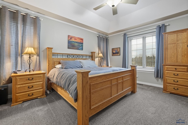 bedroom featuring ceiling fan, visible vents, baseboards, dark colored carpet, and a raised ceiling