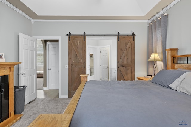 carpeted bedroom with baseboards, a barn door, and crown molding