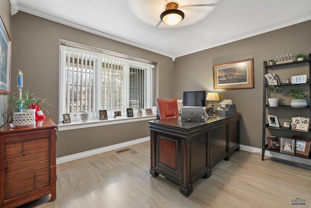 home office with baseboards, light wood finished floors, visible vents, and crown molding