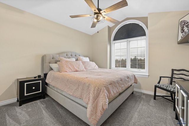 bedroom with carpet floors, vaulted ceiling, baseboards, and ceiling fan