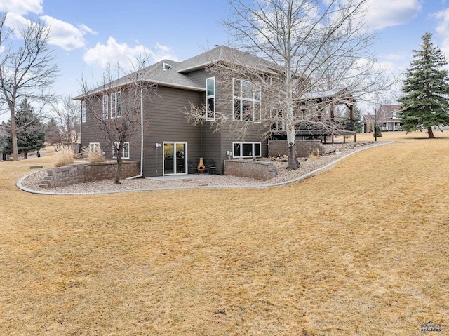 rear view of house with a lawn