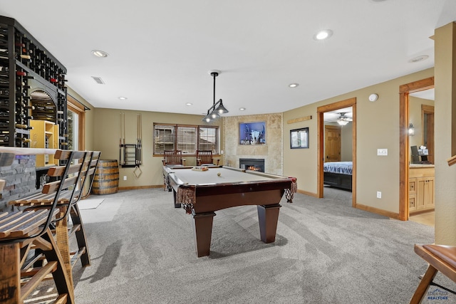 rec room featuring a large fireplace, recessed lighting, baseboards, and light colored carpet