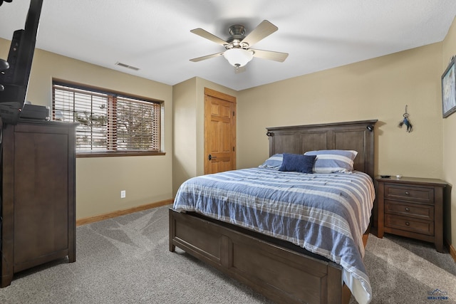 bedroom with baseboards, visible vents, a ceiling fan, and light colored carpet