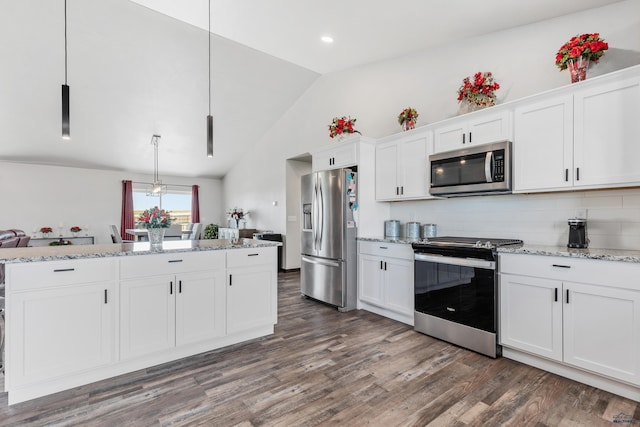 14113 Treasure Coach Rd, Piedmont, SD 57769 - kitchen with vaulted ceiling, light stone countertops, appliances with stainless steel finishes, white cabinets, and dark wood-type flooring