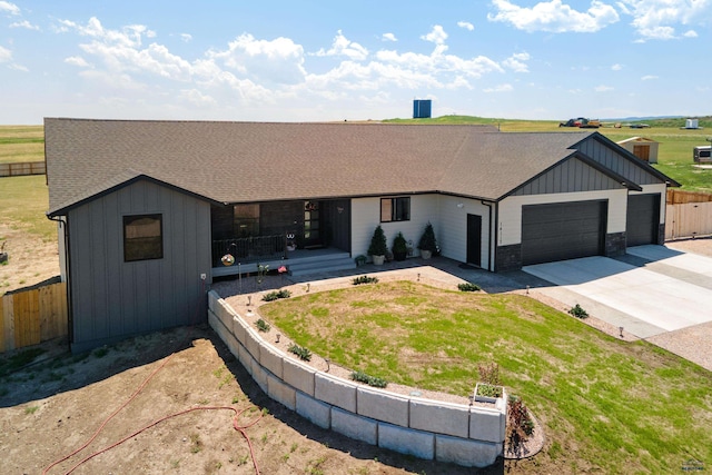 14113 Treasure Coach Rd, Piedmont, SD 57769 - ranch-style house with concrete driveway, fence, an attached garage, board and batten siding, and a shingled roof