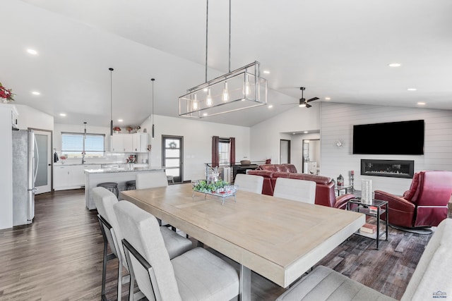 14113 Treasure Coach Rd, Piedmont, SD 57769 - dining area featuring vaulted ceiling, a ceiling fan, a glass covered fireplace, dark wood-type flooring, and recessed lighting