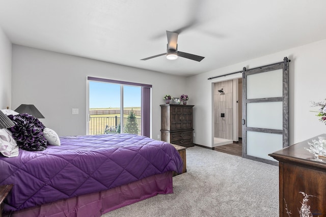 14113 Treasure Coach Rd, Piedmont, SD 57769 - carpeted bedroom featuring access to exterior, a barn door, and a ceiling fan