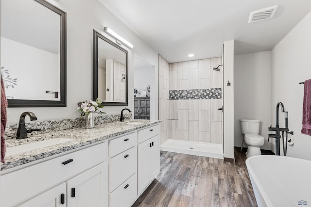 14113 Treasure Coach Rd, Piedmont, SD 57769 - full bathroom featuring double vanity, visible vents, wood finished floors, and a sink
