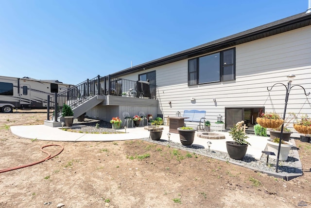 14113 Treasure Coach Rd, Piedmont, SD 57769 - rear view of property featuring stairs, a patio, and a fire pit