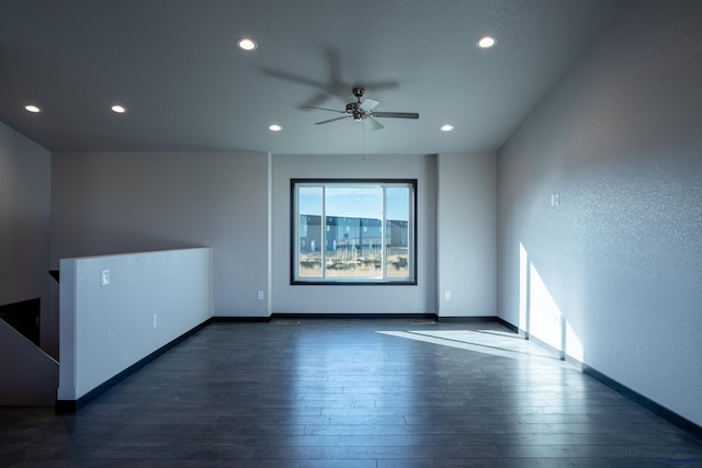 empty room with hardwood / wood-style flooring and baseboards