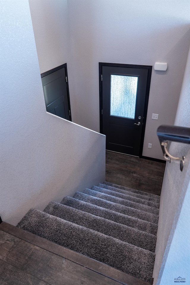 stairway featuring wood finished floors