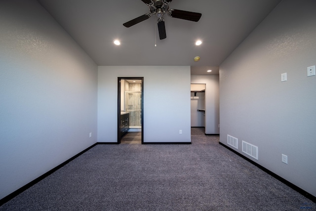 empty room featuring baseboards, visible vents, dark colored carpet, and recessed lighting