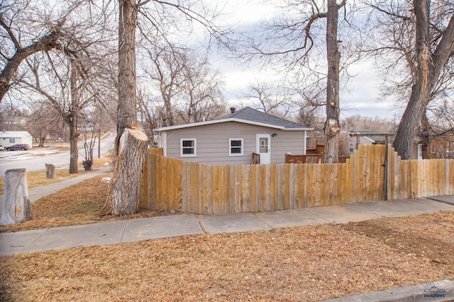 view of property exterior with a fenced front yard