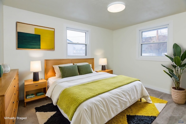 bedroom featuring carpet, multiple windows, and baseboards