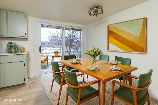 dining area with light wood-style flooring