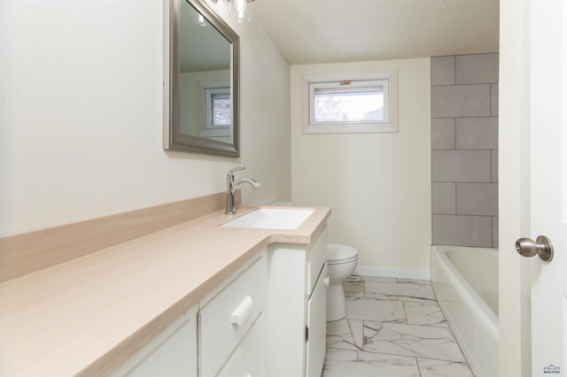 full bathroom with a tub to relax in, baseboards, toilet, marble finish floor, and vanity