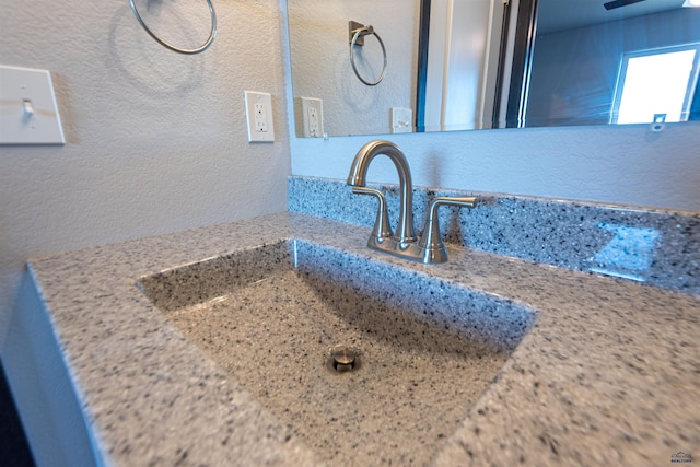 details with a textured wall and a sink