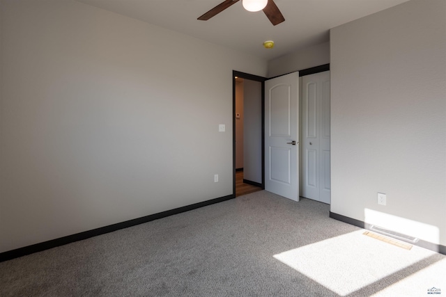 unfurnished bedroom featuring a closet, carpet, a ceiling fan, and baseboards