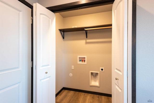 laundry room with gas dryer hookup, hookup for a washing machine, hookup for an electric dryer, laundry area, and wood finished floors