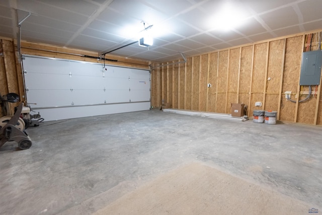 garage with a garage door opener and electric panel