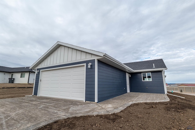 view of front of property featuring board and batten siding, concrete driveway, and an attached garage