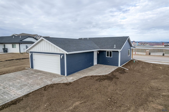 ranch-style house featuring a shingled roof and board and batten siding