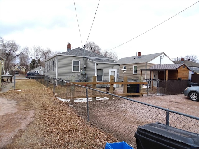 view of front facade featuring a chimney and fence